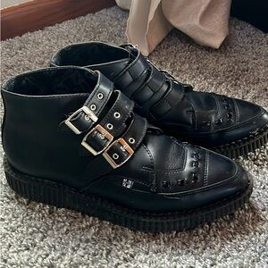 Black T.U.K Triple buckle leather shoes.